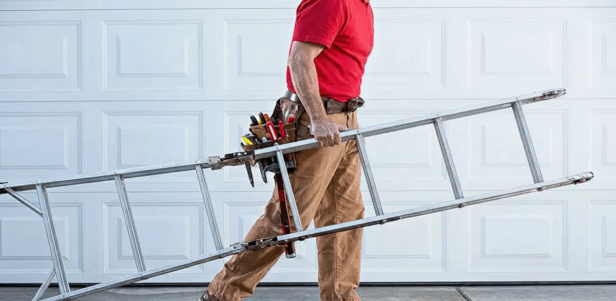 Garage door repair technician arriving with tools and ladder in Philadelphia, PA