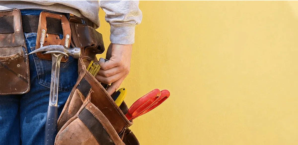 Handyman with tool belt ready for home repairs and maintenance in Philadelphia, PA